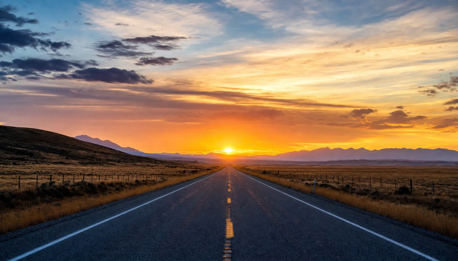 Open American highway stretching toward a sunrise horizon